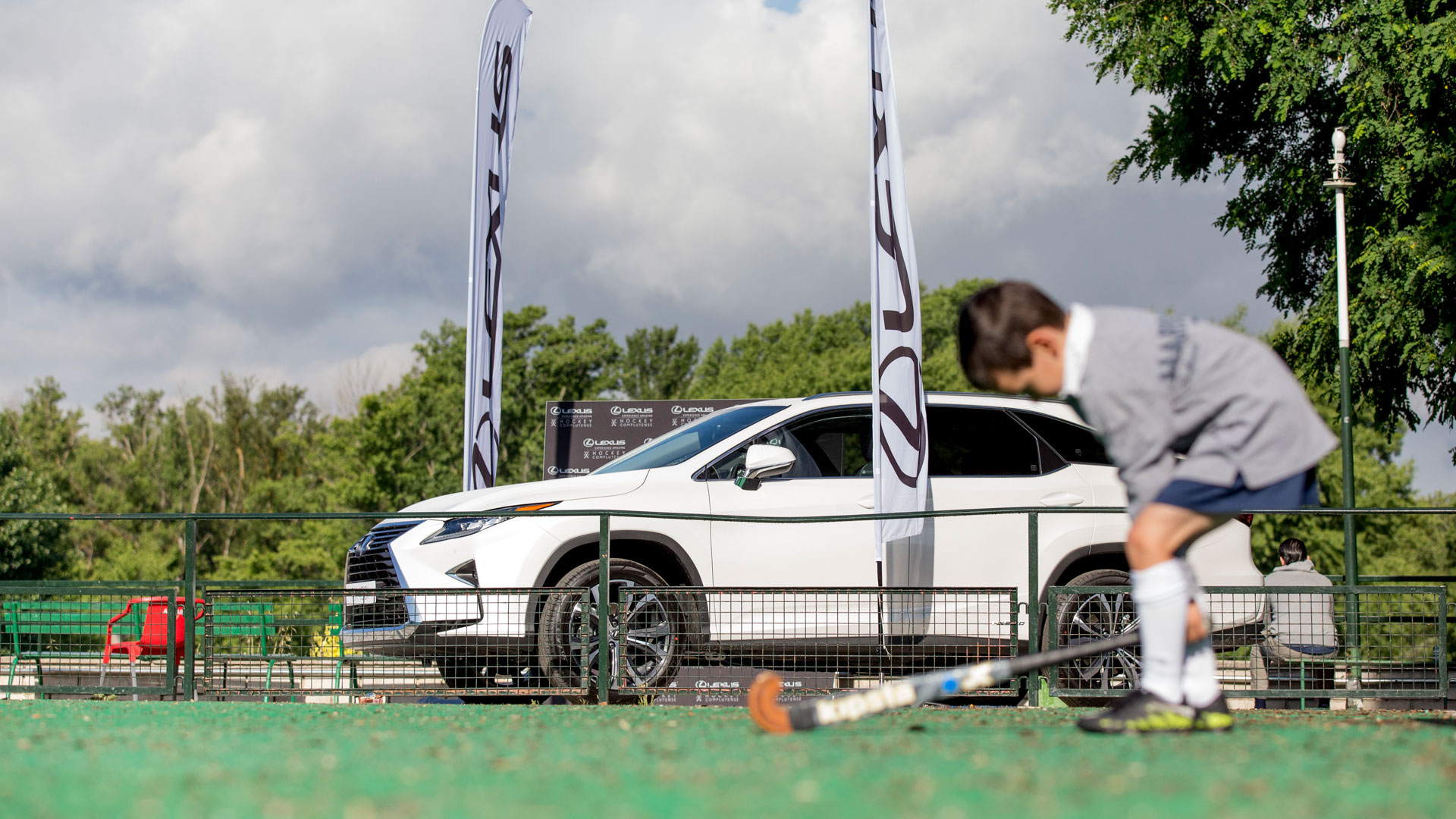 Imagen exterior del Lexus RX 450h y un niño empuñando un stick de hockey